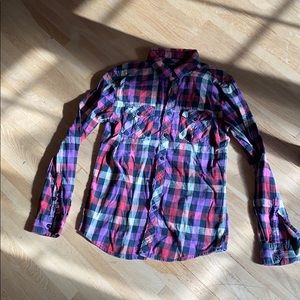 Long sleeved, plaid,  button down shirt.